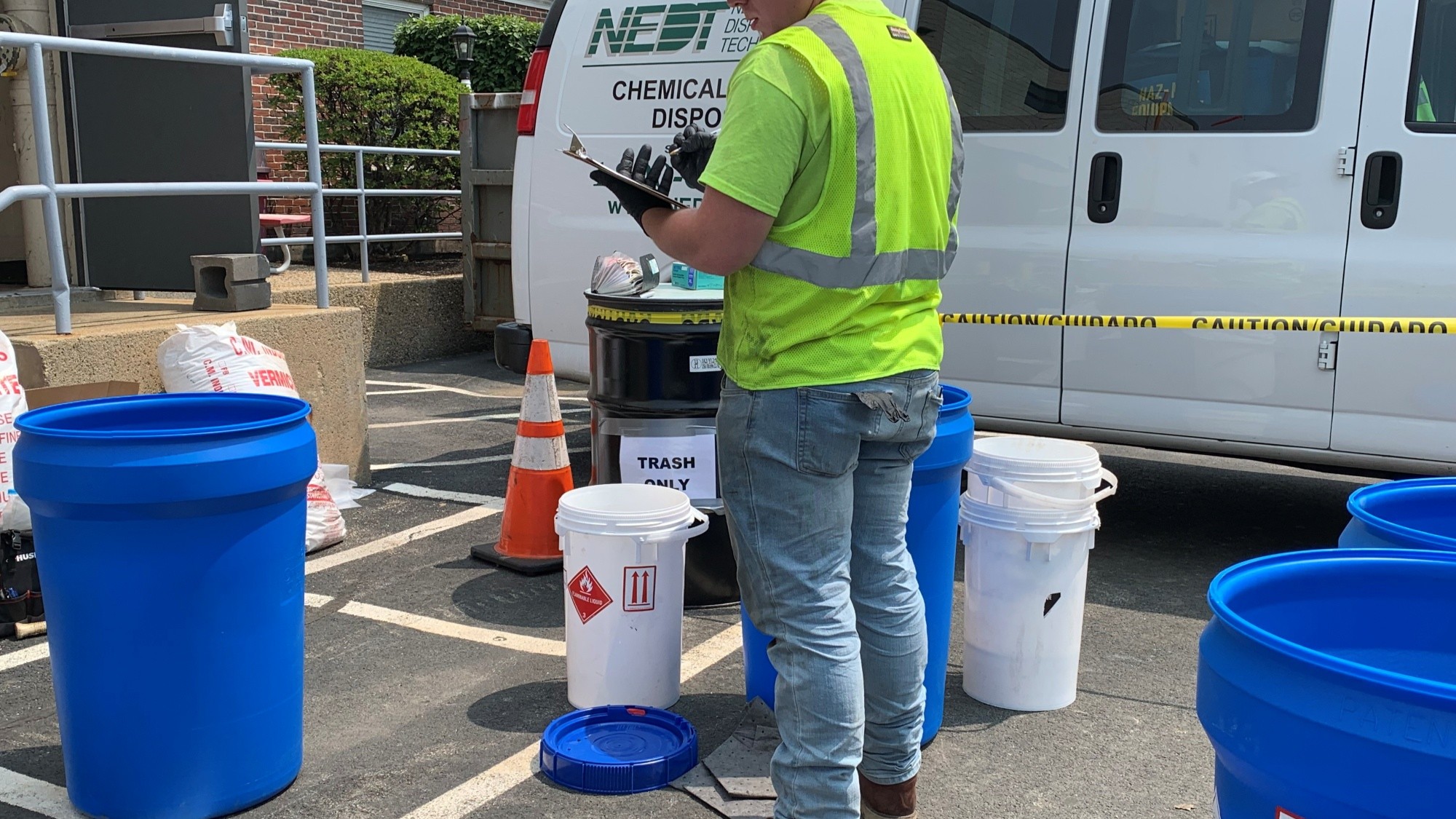 NEDT Staffer taking inventory of hazardous products prior to transport.