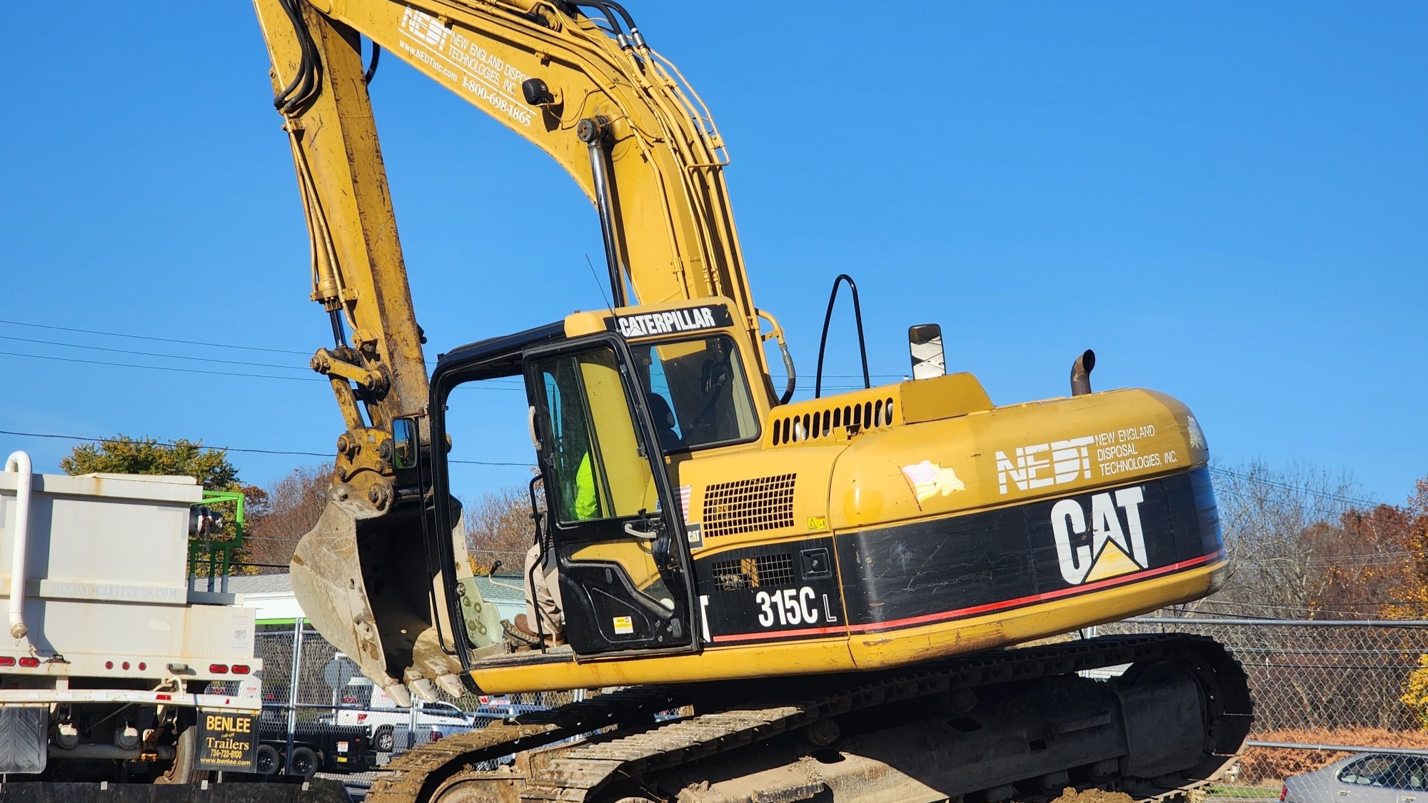 NEDT earthmover performing hazardous waste excavation at a job site.